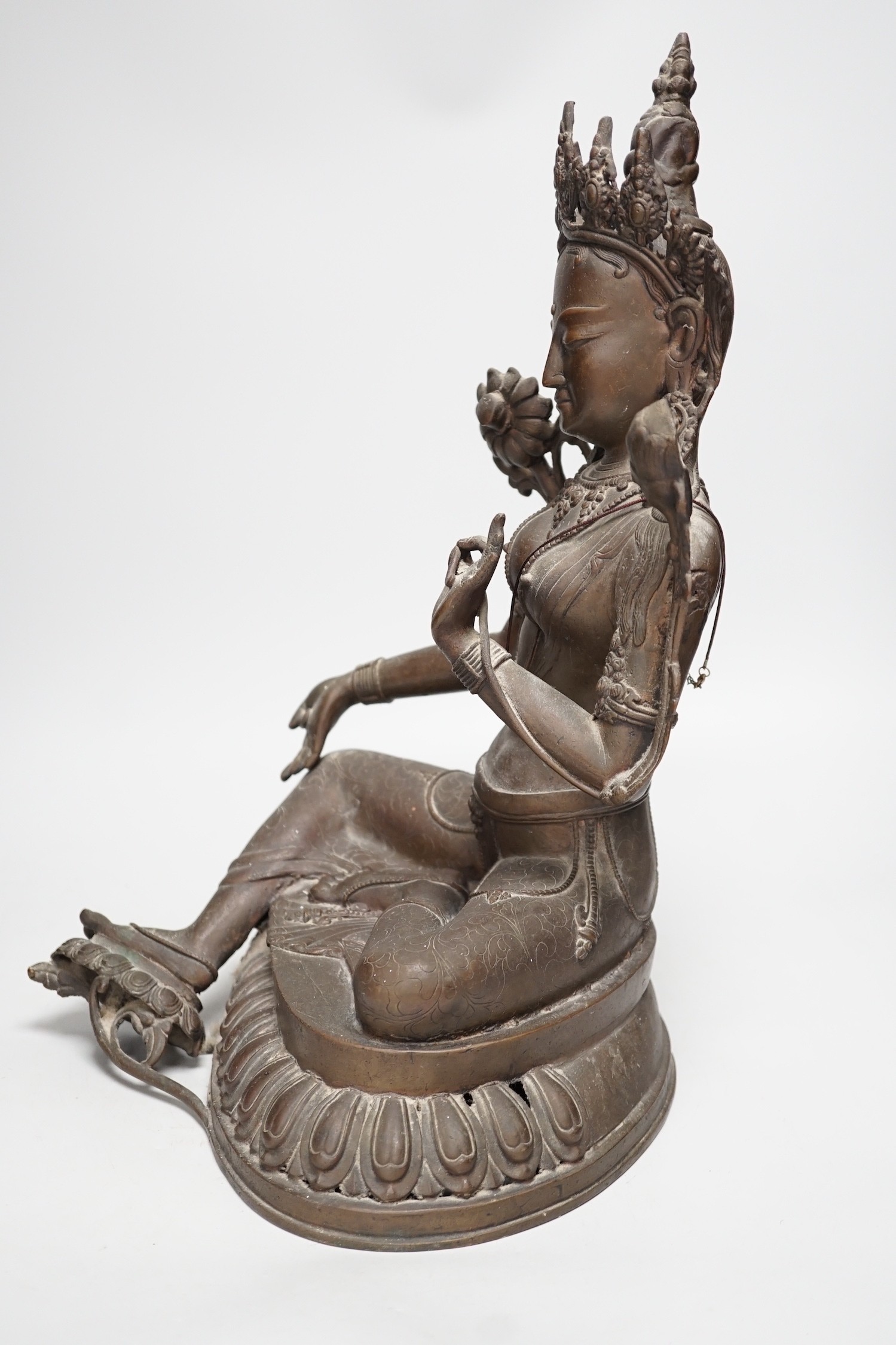 A Buddhist bronze seated figure of Green Tara. 42cm tall